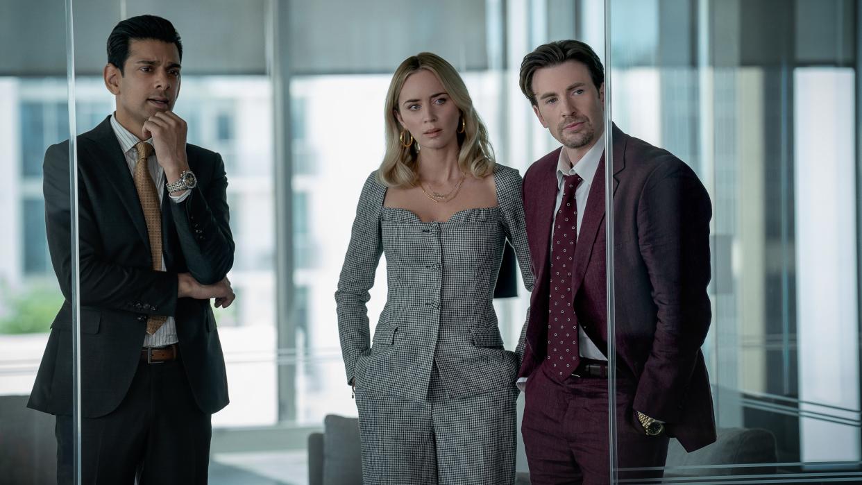  Amit Shah, Emily Blunt and Chris Evans in an office in Pain Hustlers. 