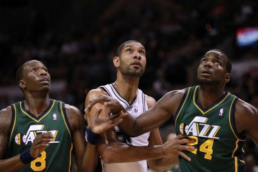 San Antonio Spurs' Tim Duncan (C) waits for the rebound with Josh Howard (L) and Paul Millsap (R) of the Utah Jazz during game two of the NBA Western Conference first-round playoff series on May 2. San Antonio pummelled Utah 114-83 to take a 2-0 lead