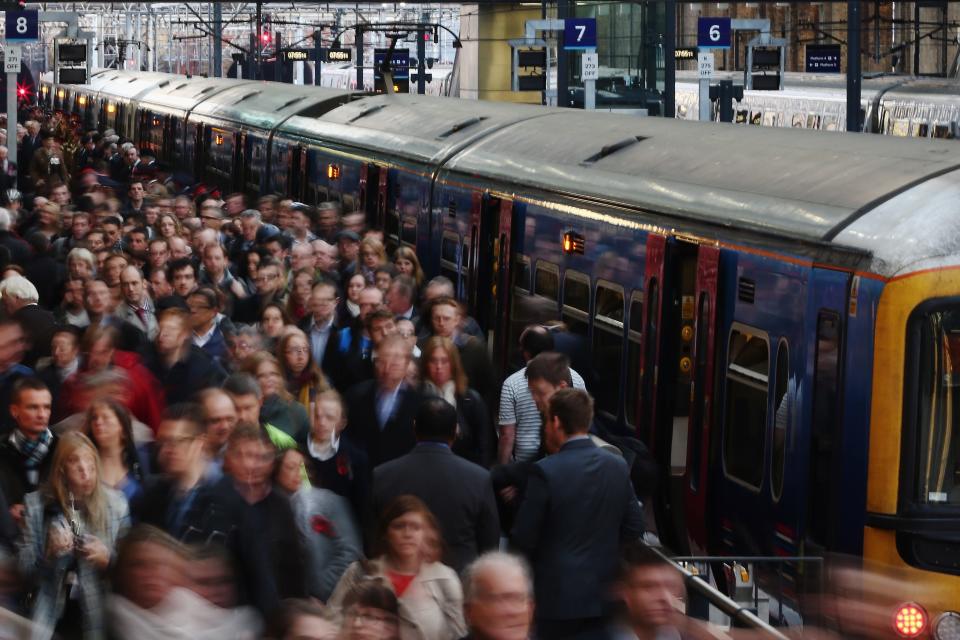 Passengers disembark from a train.