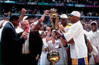 Los Angeles Lakers owner Jerry Buss is interviewed by sportscaster Ahmad Rashad while his team celebrates winning the NBA Championship after defeating the Indiana Pacers in Game Six of the 2000 NBA Finals on June 19, 2000 at the Staples Center in Los Angeles, California. (Photo by Andrew D. Bernstein/NBAE via Getty Images)