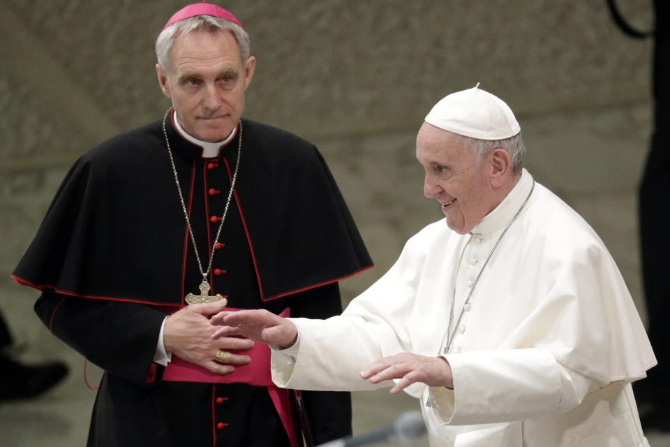 FILE - Prefect of the Papal Household Archbishop Georg Gaenswein, left, looks at Pope Francis as he arrives for an audience with participants of a pilgrimage of the Italian-Albanian diocese of Lungro, in the Pope Paul VI hall, at the Vatican, Saturday, May 25, 2019. Pope Francis met on Monday, Jan. 9, 2023, with Archbishop Gaenswein, the longtime secretary of Pope Benedict XVI who was a key figure in his recent funeral but who has raised eyebrows with an extraordinary memoir in which he settles old scores and reveals palace intrigue. (AP Photo/Andrew Medichini, File)
