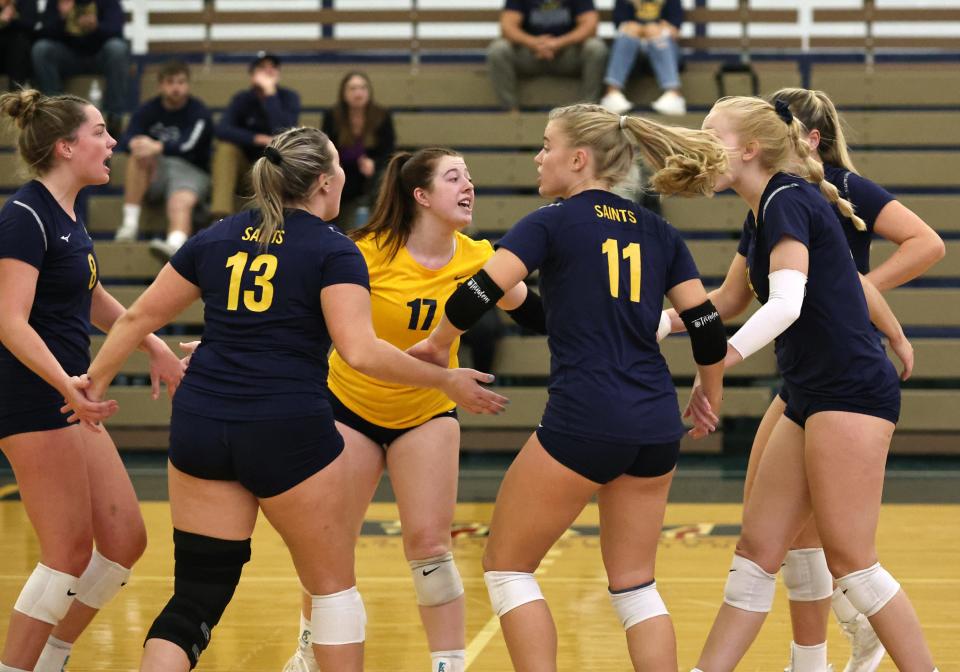 The Siena Heights volleyball team celebrates a point during Wednesday's match against Michigan Dearborn.