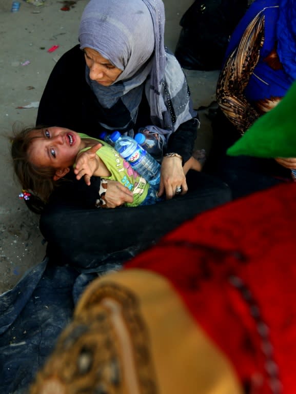 Syrians from Raqa are seen in the city's western suburb of Jazra on June 27, 2017, after fleeing areas under the control of the Islamic State group