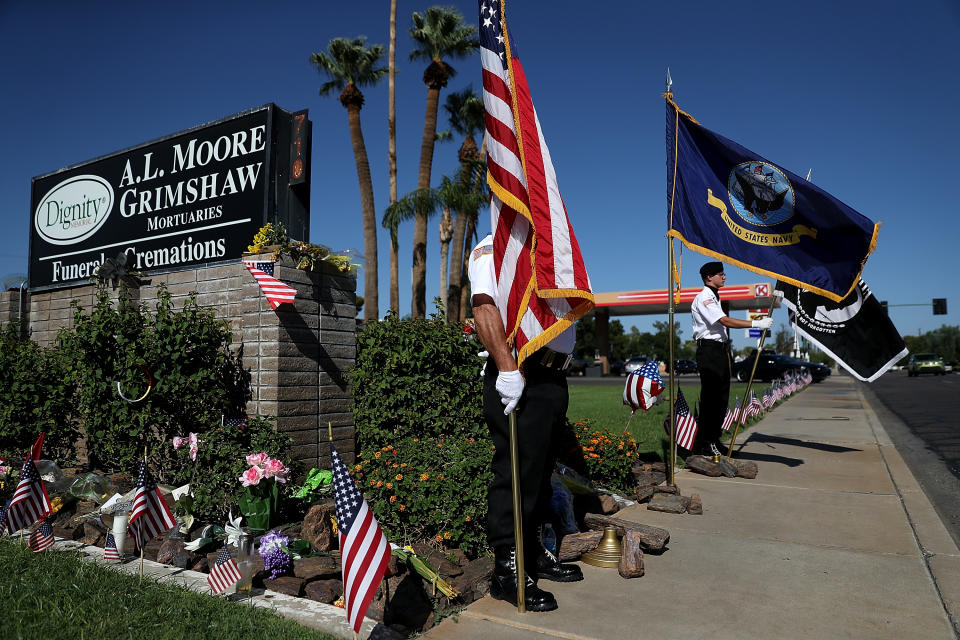 <p>Members of the POW-MIA-KIA Honor Guard stand watch at a makeshift memorial for Sen. John McCain (R-AZ) outside of the A.L. Moore Grimshaw mortuary on August 27, 2018 in Phoenix, Ariz. (Photo: Justin Sullivan/Getty Images) </p>