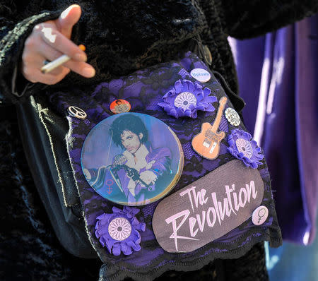 Prince memorabilia covers a fan's purse as thousands gather for an all-star concert paying tribute to Prince, six months after the influential pop star died, in St. Paul, Minnesota, U.S., October 13, 2016. REUTERS/Craig Lassig