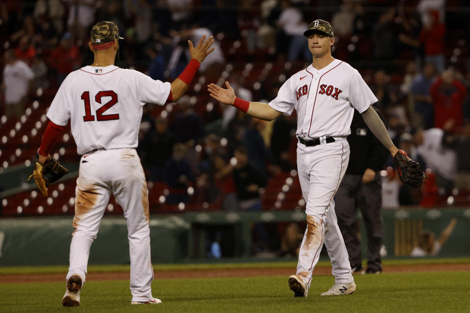 Boston Red Sox's Bobby Dalbec is congratulated by Marwin Gonzalez (12) after their win over the Los Angeles Angels in a baseball game Friday, May 14, 2021, at Fenway Park in Boston. (AP Photo/Winslow Townson)