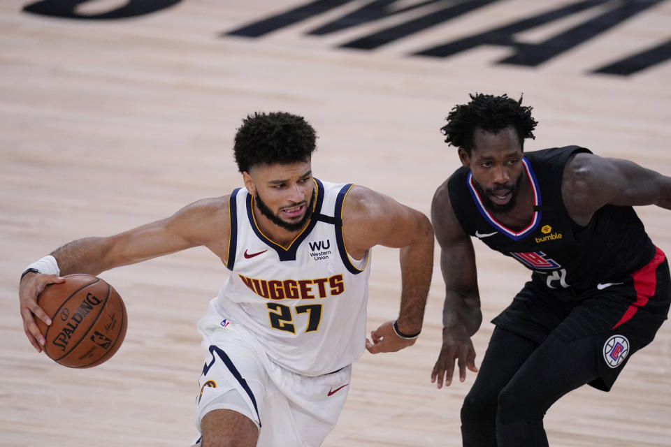 Denver Nuggets guard Jamal Murray (27) drives around LA Clippers guard Patrick Beverley (21) during the first half of an NBA conference semifinal playoff basketball game Tuesday, Sept. 15, 2020, in Lake Buena Vista, Fla. (AP Photo/Mark J. Terrill)