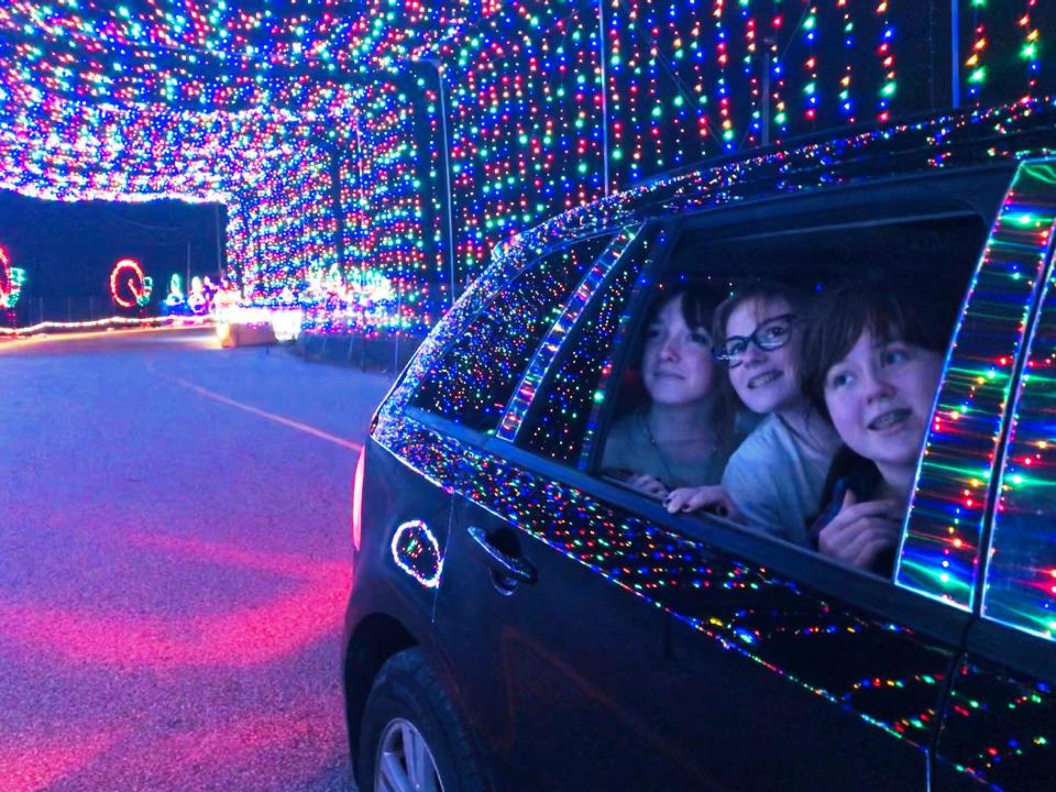 Taking in the lights at a preview of the Magic of Lights drive-through experience being hosted by Gillette Stadium last year are, from left, Jazzlyn Johnson, 15; Molly Arnold, 14, and Kathryn McCarron, 14, all of North Attleborough. The show will run nightly through Jan. 1.