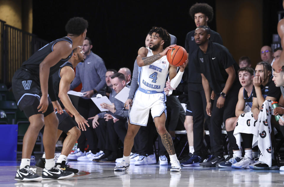 In a photo provided by Bahamas Visual Services, North Carolina's RJ Davis looks to pass the ball during an NCAA college basketball game in the Battle 4 Atlantis at Paradise Island, Bahamas, Thursday, Nov. 23, 2023. (Tim Aylen/Bahamas Visual Services via AP)