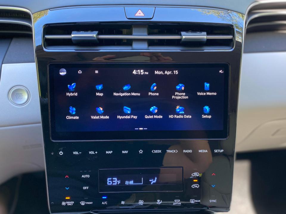 A 2024 Hyundai Tucson Hybrid's center console with a 10.25-inch touchscreen infotainment screen and touch-sensitive climate controls.