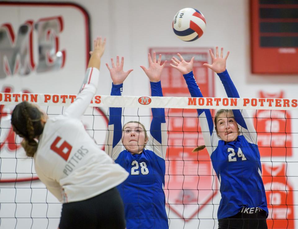Limestone's Ella Karmenzind (24) and Liz Grube (28) try to defend against Morton's Graci Junis in the second set of their volleyball match Wednesday, Sept. 13, 2023 in Morton. The Rockets downed the Potters in straight sets 25-23, 26-24.