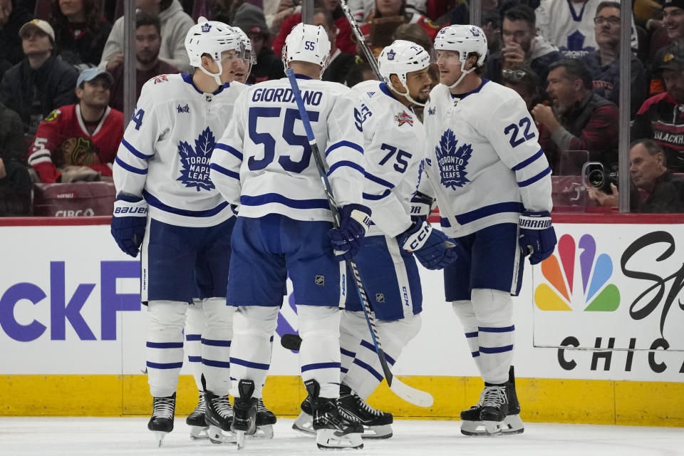 Toronto Maple Leafs right wing Ryan Reaves (75) and teammates celebrate his goal against the Chicago Blackhawks during the second period of an NHL hockey game Friday, Nov. 24, 2023, in Chicago. (AP Photo/Erin Hooley)