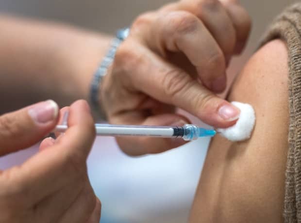 More than 14 per cent of eligible New Brunswickers aged 12 and older have now received two doses of a COVID-19 vaccine. (Ryan Remiorz/The Canadian Press - image credit)