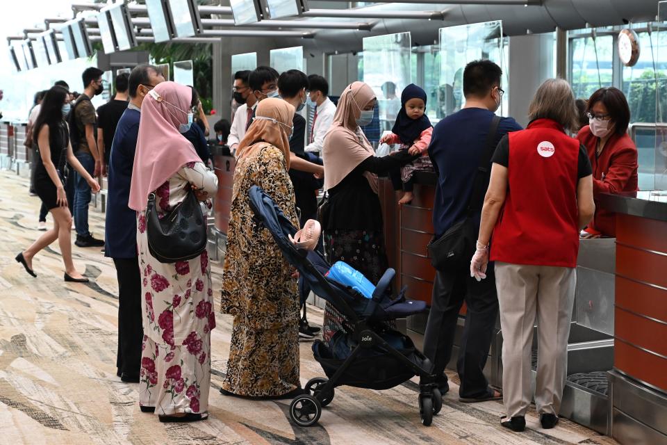 Diners register at the check-in counter for the inaugural lunch at Restaurant A380 @Changi at Changi International Airport in Singapore.