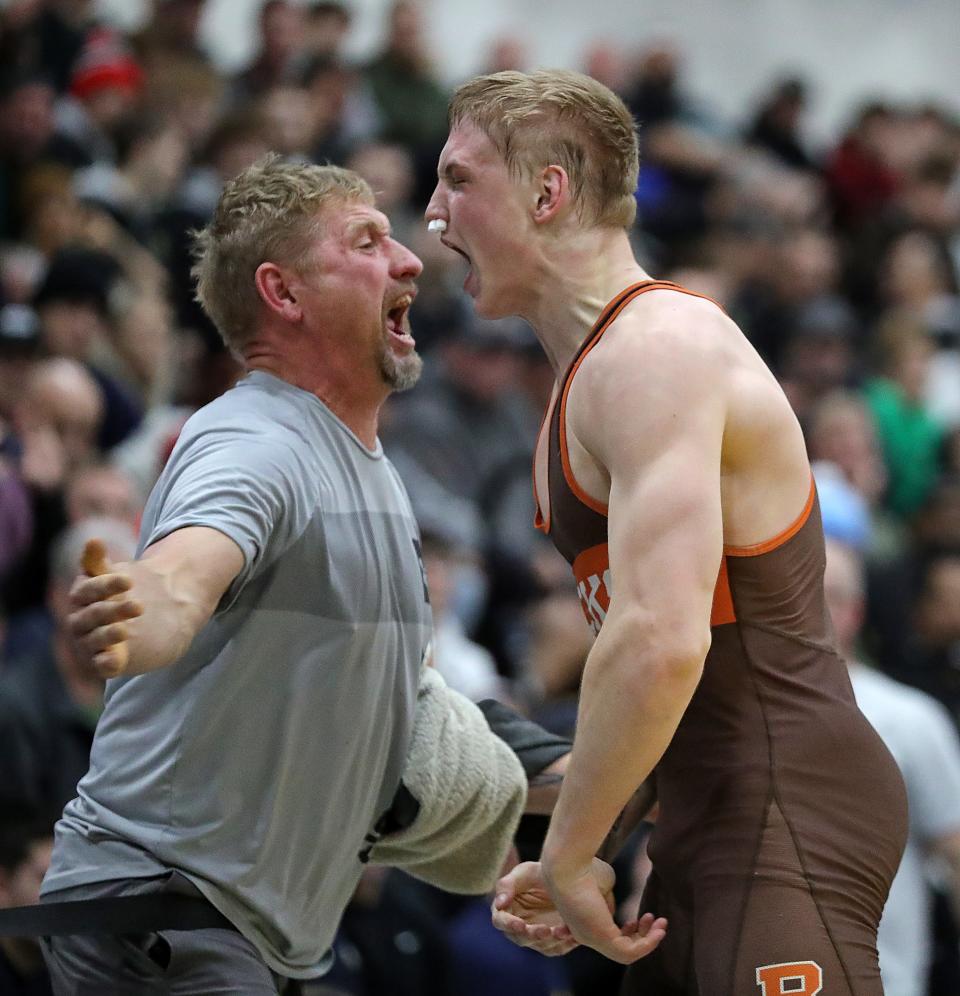 Eddie Neitenbach of Buckeye, right, celebrates with his dad Dylan after capturing third place at the Ironman with a win against Tyler Eise of Ponderosa, Col.