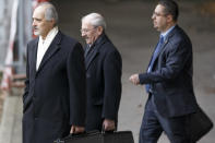 Syrian chief negotiator Bashar Ja'afari, left, Ambassador of the Permanent Representative Mission of the Syria to UN New York, leaves the meeting, at the European headquarters of the United Nations, in Geneva, Switzerland, Sunday, Jan. 26, 2014. Syrians on opposite sides of their country’s civil war tried again Sunday to find common ground, with peace talks focusing on an aid convoy to a besieged city that once more came under mortar attack from the government. (AP Photo/Keystone,Salvatore Di Nolfi)