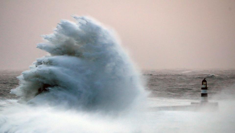 Waves crash against the pier wall at Seaham Lighthouse during Storm Arwen, in Seaham (REUTERS)