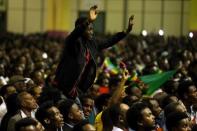 A resident cheers as he attends a concert at the Millennium Hall in Addis Ababa, Ethiopia July 15, 2018. REUTERS/Tiksa Negeri