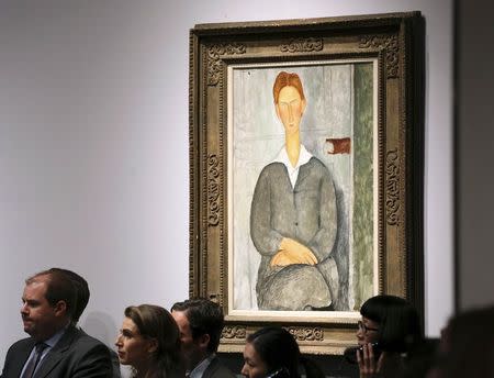 The artwork titled "Jeune homme roux assis" by artist Amedeo Modigliani is seen during a Christie's auction in New York May 6, 2014. REUTERS/Adam Hunger