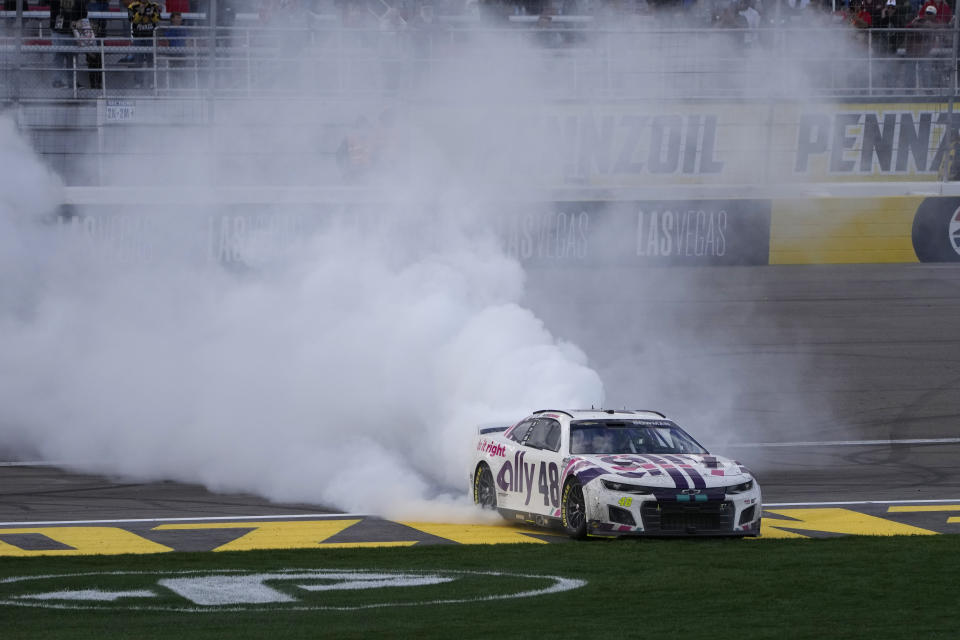 Alex Bowman (48) does a burnout after winning a NASCAR Cup Series auto race Sunday, March 6, 2022, in Las Vegas. (AP Photo/John Locher)