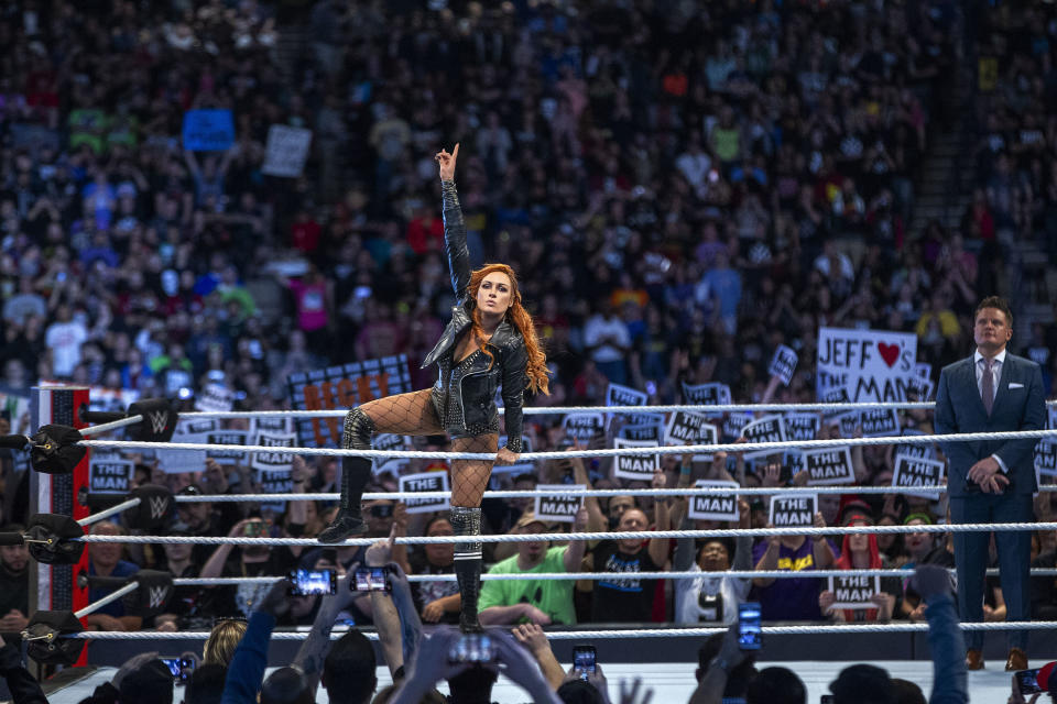 Becky Lynch gestures to fans at a WWE event. (WWE)