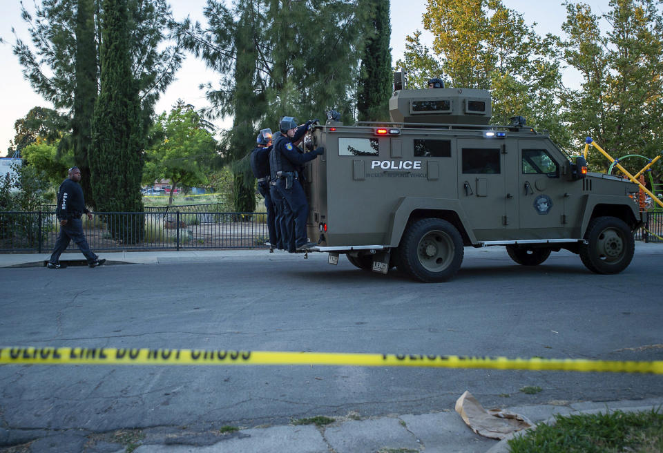 Sacramento police officers respond to a shooting on Redwood Avenue in the Noralto neighborhood, Wednesday, June 19, 2019, in Sacramento, Calif. (Paul Kitagaki Jr./The Sacramento Bee via AP)