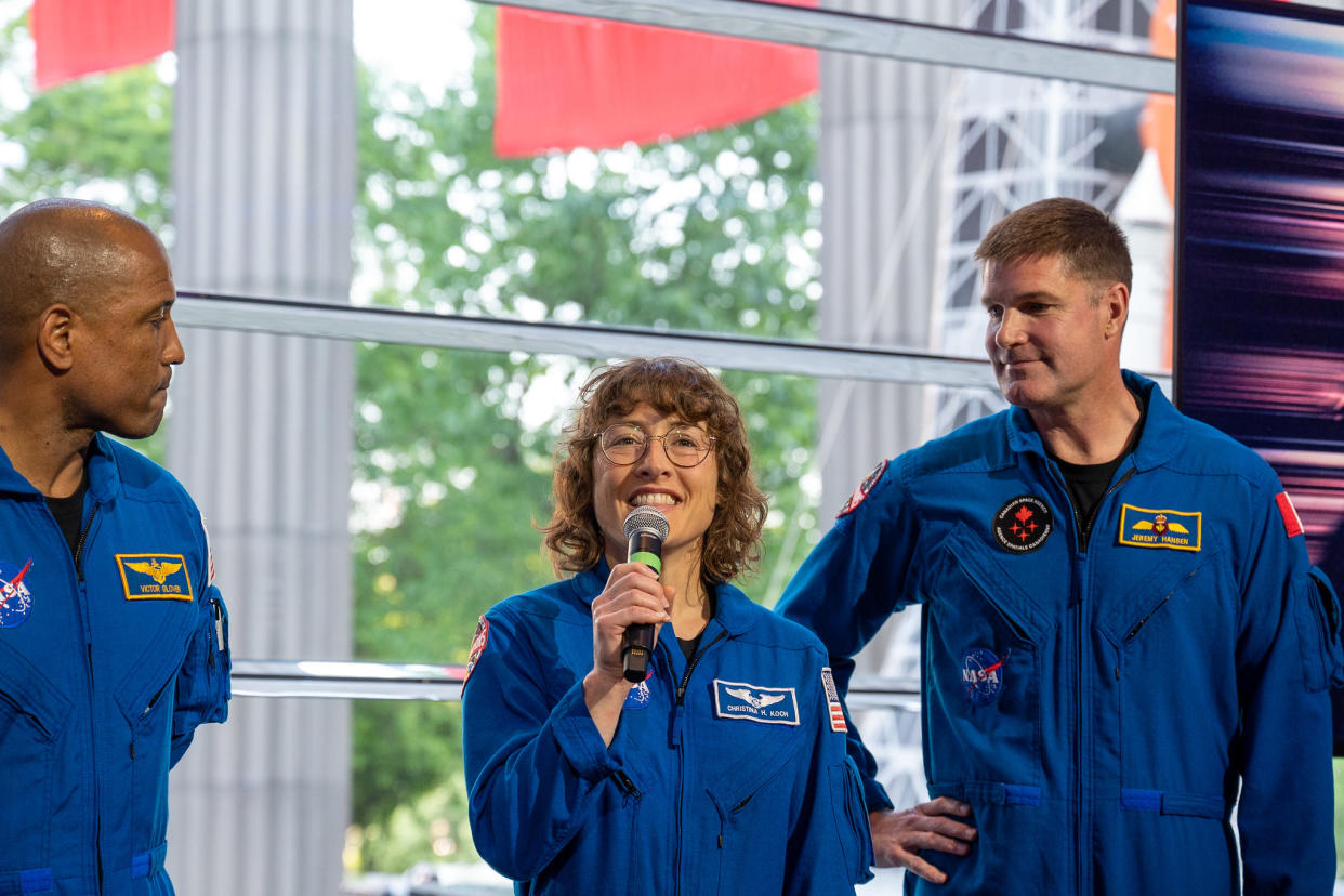  NASA's Christina Hammock Koch, flanked by fellow Artemis 2 astronauts Victor Glover of NASA (left) and Jeremy Hansen of the Canadian Space Agency, delivers remarks on May 17, 2023, during a reception at the Canadian Embassy in Washington, D.C.  