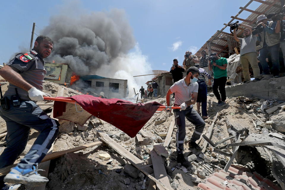 Palestinians remove a body from the site of an Israeli airstrike in Gaza City, May 17, 2021. / Credit: MOHAMMED SALEM/REUTERS