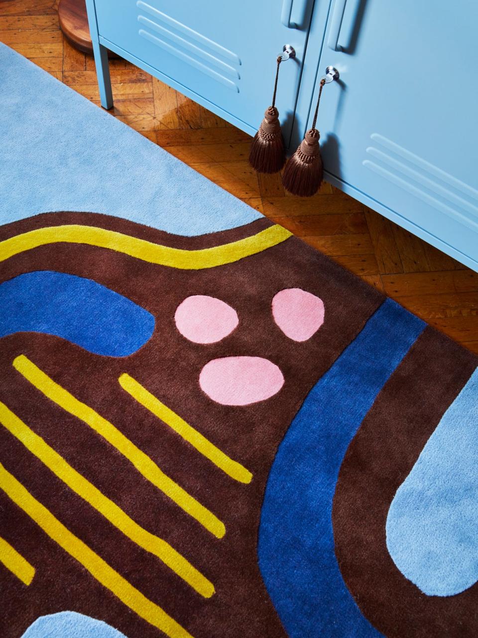 Closeup of rug with pink and blue