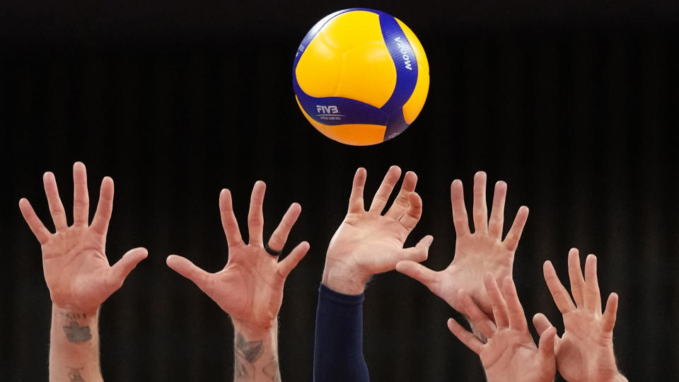 <p>United States's players reach up to block a return ball during a men's volleyball preliminary round pool B match against France, at the 2020 Summer Olympics in Tokyo, Japan. (AP Photo/Frank Augstein)</p> 