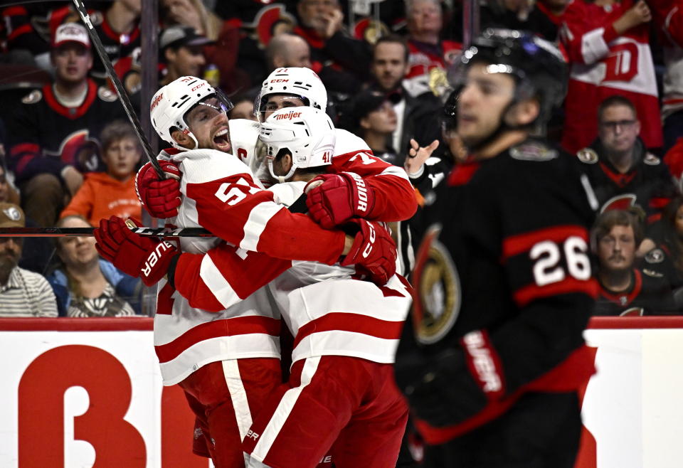 Detroit Red Wings left wing David Perron (57) celebrates a goal against the Ottawa Senators as defenceman Erik Brannstrom (26) skates by during the second period of an NHL hockey game in Ottawa, Ontario, Saturday, Oct. 21, 2023. (Justin Tang/The Canadian Press via AP)