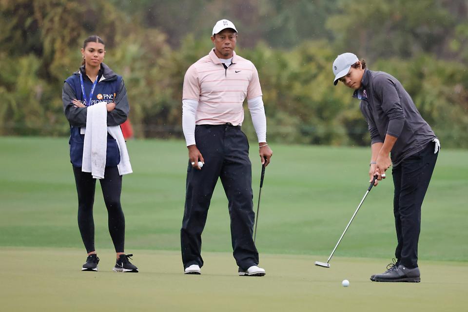 Dec 16, 2023; Orlando, Florida, USA; Tiger Woods (center) and is daughter Sam Woods (left) watch as Charlie Woods sends his putt on the fifth green during the PNC Championship at The Ritz-Carlton Golf Club. Mandatory Credit: Reinhold Matay-USA TODAY Sports