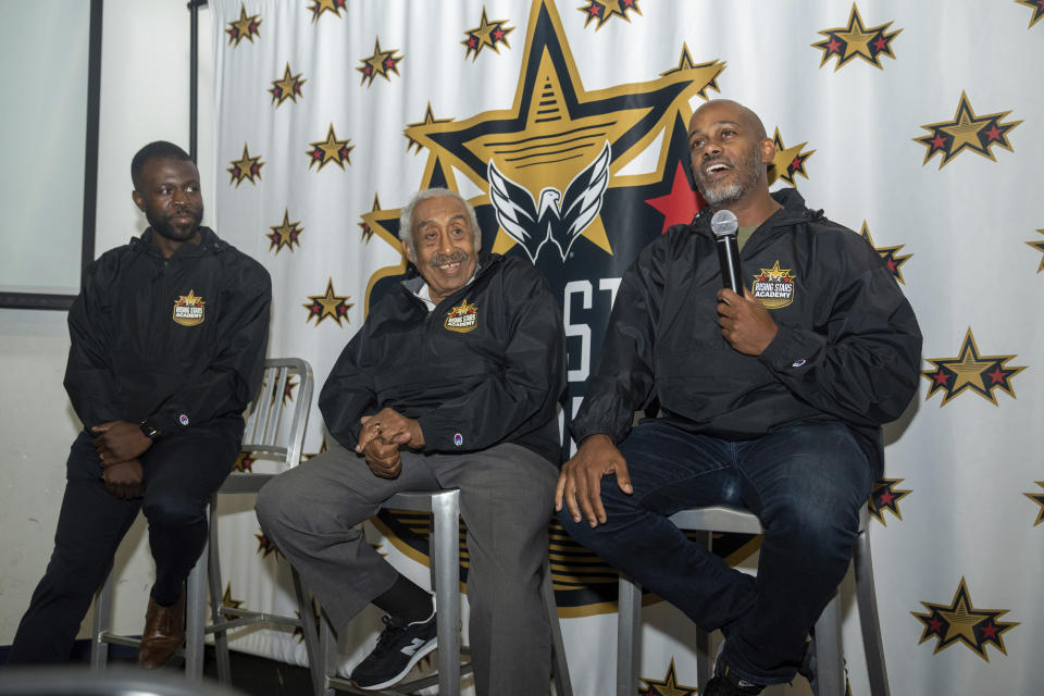 This photo provided by the Washington Capitals shows former Navy hockey captain Ralph Featherstone, right, along with instructor Duante' Abercrombie, left, and Fort Dupont Cannons coach Neal Henderson speaking to players at the Washington Capitals' Rising Stars Academy, Sunday, Aug. 20, 2023, at MedStar Capitals IcePlex in Arlington, Virginia. The goal was to provide assistance and direction for families who have chosen the sport and now are looking to take the next step. It was also an opportunity for players of color to feel a sense of community and know they're not alone. (Jess Rapfogel/Washington Capitals via AP)