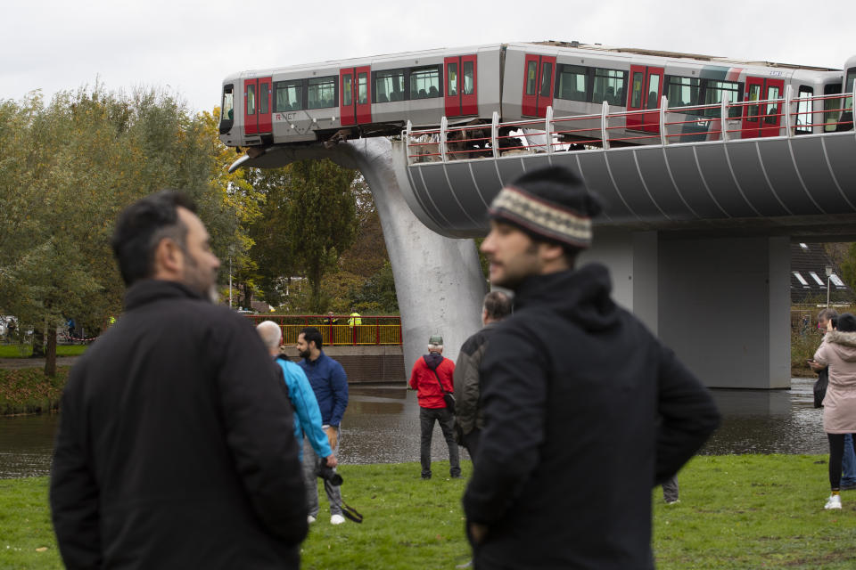 The whale's tail of a sculpture caught the front carriage of a metro train as it rammed through the end of an elevated section of rails with the driver escaping injuries in Spijkenisse, near Rotterdam, Netherlands, Monday, Nov. 2, 2020. (AP Photo/Peter Dejong)