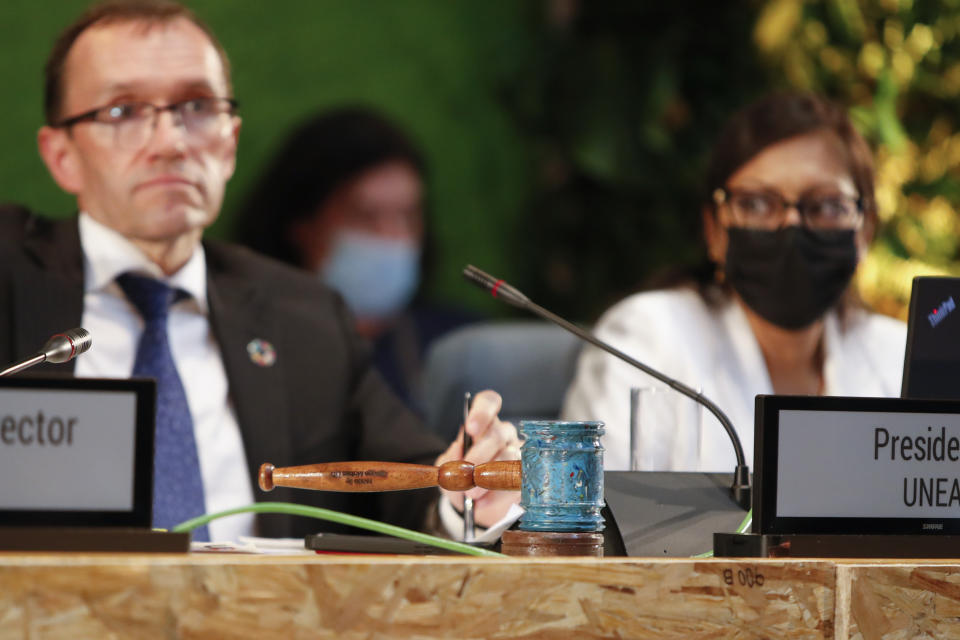 A gavel made from recycled plastics sits on the podium next to Espen Barth Eide, left, Norway's Minister of Climate and the Environment, at the U.N. Environment Assembly (UNEA) held at UNEP headquarters in Nairobi, Kenya Wednesday, March 2, 2022. The assembly unanimously voted Wednesday to start to create a legally binding global treaty to address plastic pollution in the world's oceans, rivers and landscape. (AP Photo/Brian Inganga)
