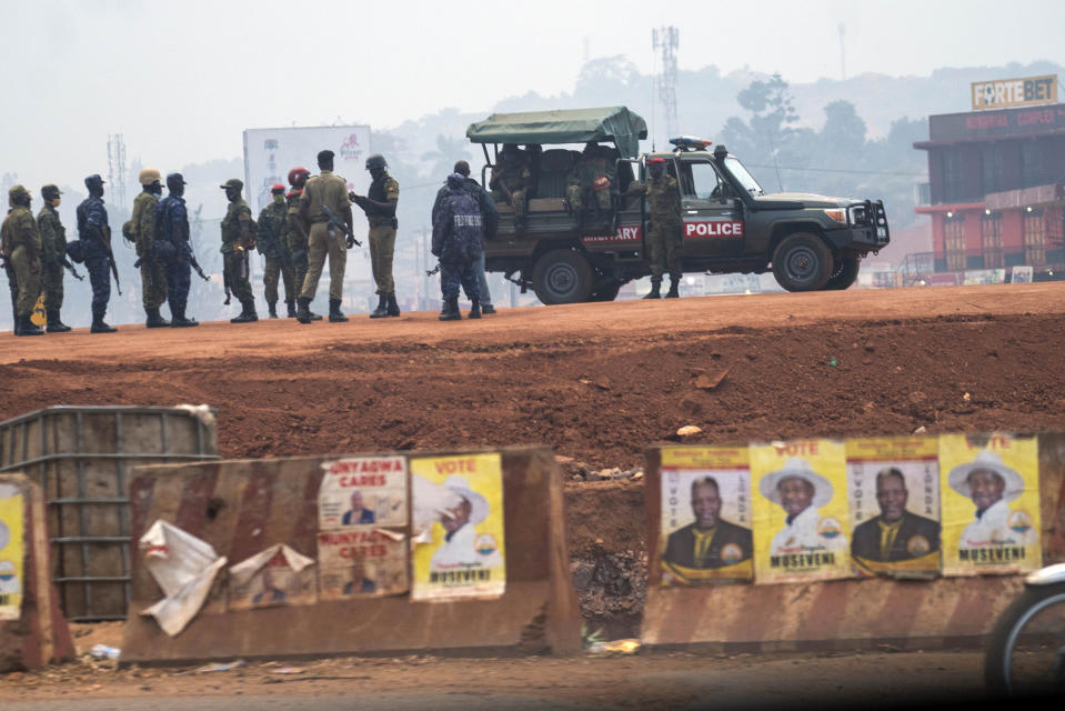 FILE - In this Thursday, Jan. 14, 2021 file photo, security forces gather on election day in Kampala, Uganda. The United States said Friday, April 16, 2021 that it is imposing visa restrictions on "those believed to be responsible for, or complicit in, undermining the democratic process in Uganda," including during the election in January and the campaign period. (AP Photo/Jerome Delay, File)