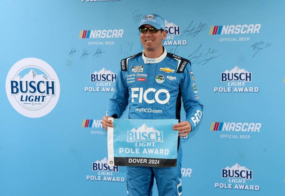 Apr 27, 2024; Dover, Delaware, USA; NASCAR Cup Series driver Kyle Busch stands with the Busch Light Pole Award after winning the pole during qualifying for the Wurth 400 at Dover Motor Speedway.