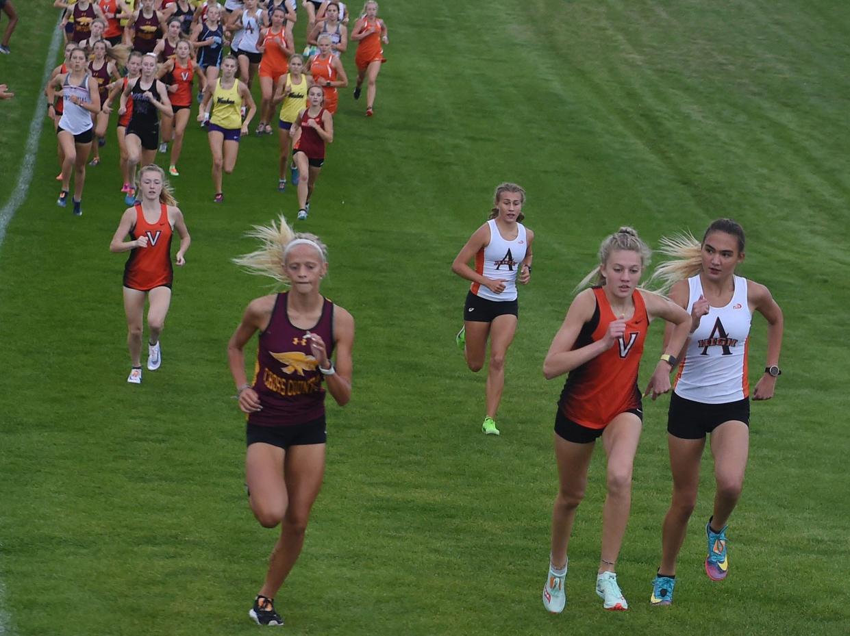 West Des Moines Valley's Kamryn Ensley, Ankeny's Alli Macke, Ames' Marley Turk, West Des Moines Valley's Addison Dorenkamp, and Ames' Claire Helmers battle for the lead at the beginning of a 2021 race