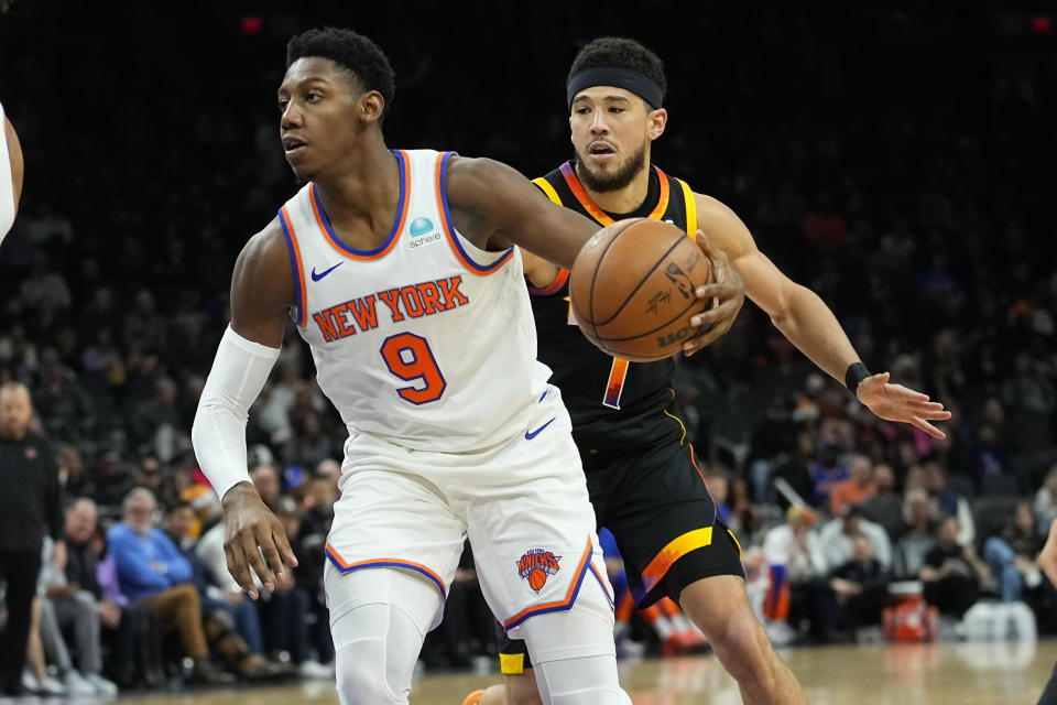 New York Knicks guard RJ Barrett (9) drives against the Phoenix Suns during the second half of an NBA basketball game, Friday, Dec. 15, 2023, in Phoenix. (AP Photo/Matt York)