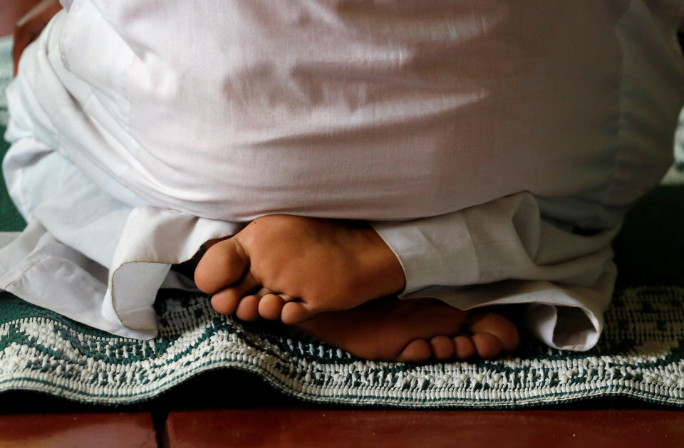 A muslim faithful attends prayers at the Makina mosque, during celebrations marking the Muslim holiday of Eid al-Adha amid the spread of the coronavirus disease (COVID-19), in Kibera settlement of Nairobi, Kenya July 31, 2020. REUTERS/Thomas Mukoya