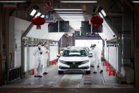 Employees work on a production line inside a Dongfeng Honda factory in Wuhan