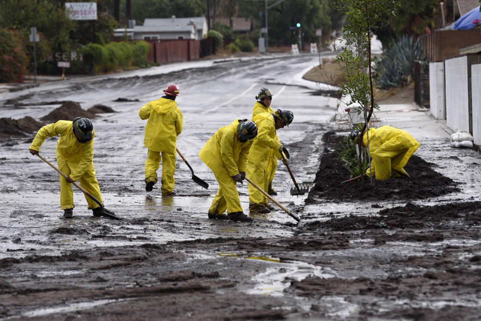 Firefighters clear debris from a mudslide in Los Angeles.