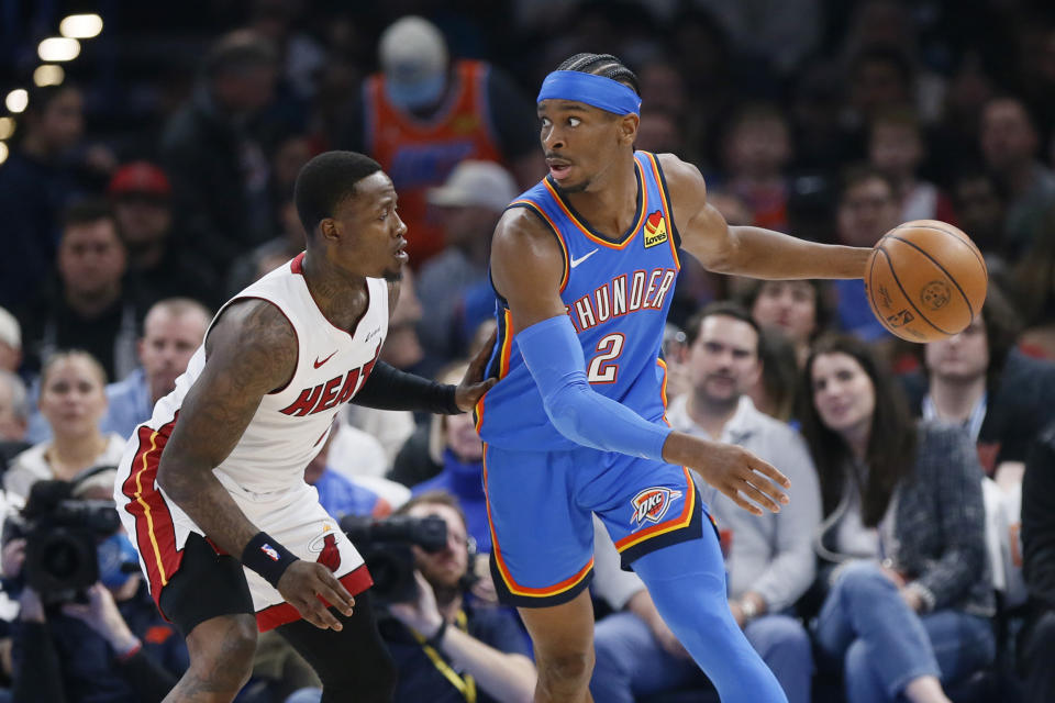 Oklahoma City Thunder guard Shai Gilgeous-Alexander (2) is defended by Miami Heat guard Terry Rozier, left, during the first half of an NBA basketball game Friday, March 8, 2024, in Oklahoma City. (AP Photo/Nate Billings)