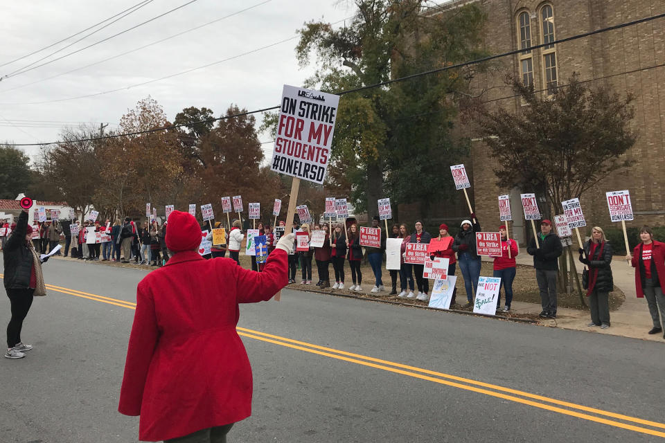 Teachers, parents and students picket outside Central High School in Little Rock, Arkansas on Thursday, Nov. 14, 2019. Teachers are staging what's being billed as a one-day strike to protest the state's control of the local school district and their loss of collective bargaining rights. (AP Photo/Andrew Demillo)