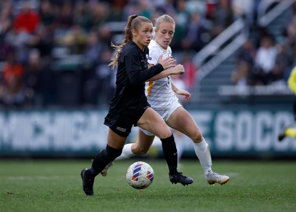 Michigan State's Lauren DeBeau, left, attacks against Minnesota's Megan Gray, Sunday, Oct. 30, 2022, in East Lansing.