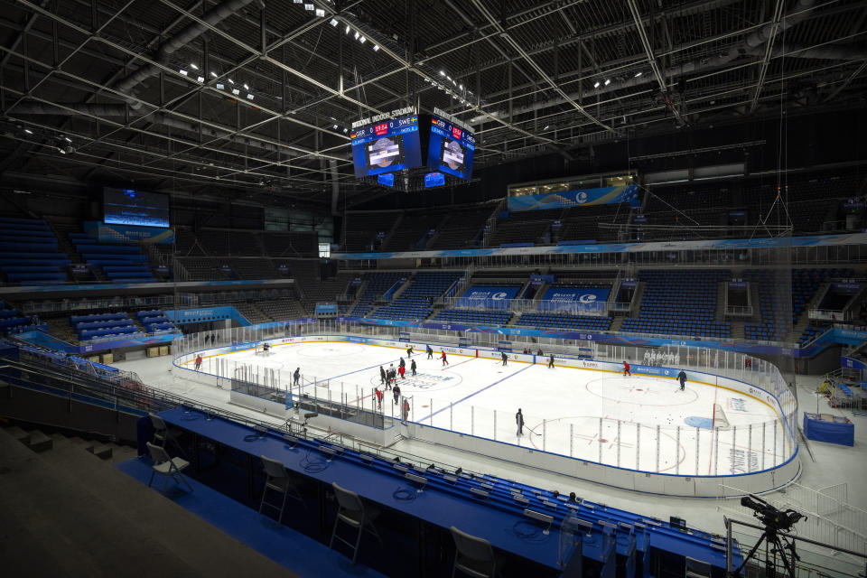 FILE - The China Ice Sports College hockey team practices on the ice during the Experience Beijing Ice Hockey Domestic Test Activity, a test event for the 2022 Beijing Winter Olympics, at the National Indoor Stadium in Beijing, Nov. 10, 2021. China's men's team is ranked 32nd in the world and is in a group with the United States and Canada, two of the medal favorites among the 12 teams going to the Winter Games in February. (AP Photo/Mark Schiefelbein, File)