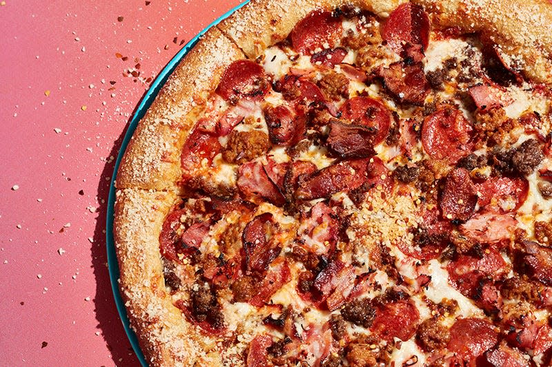 Mellow Mushroom's Mighty Meaty pizza: red sauce base with mozzarella, pepperoni, sausage, ground beef, ham and applewood smoked bacon.