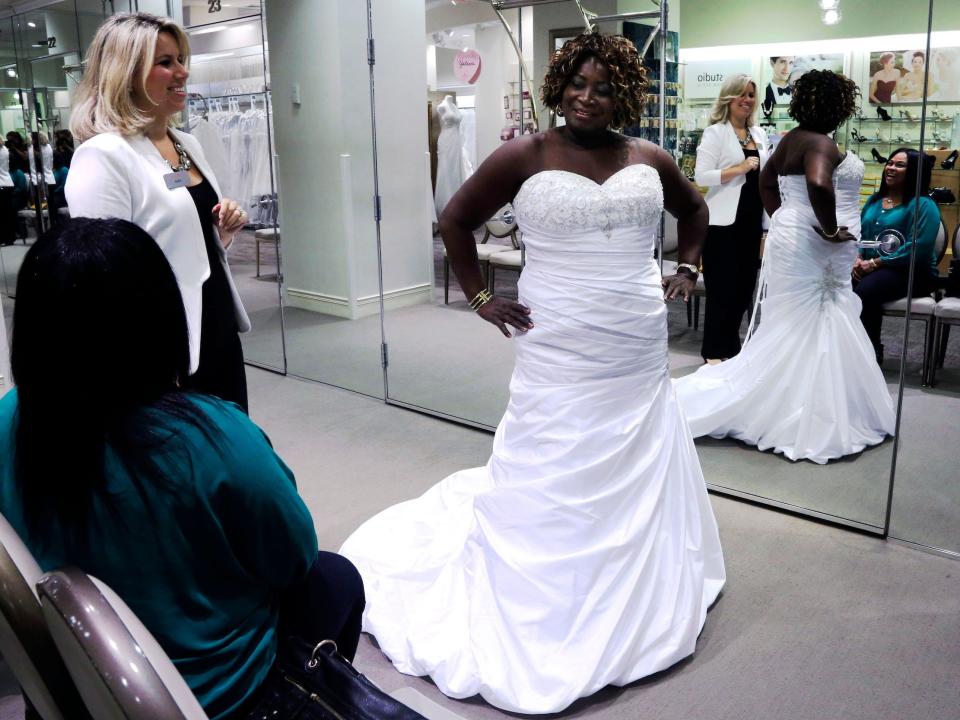 Woman tries on wedding gown at David's Bridal store