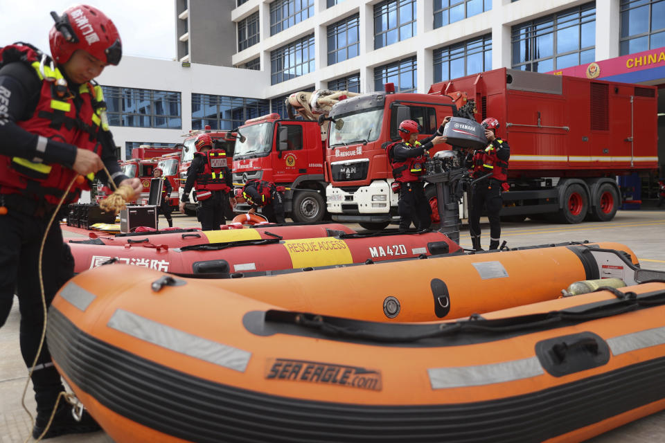 In this photo released by Xinhua News Agency, firefighters check on rescue boats as they prepare for Typhoon Doksuri in Haicang District of Xiamen in southeast China's Fujian Province on July 26, 2023. The coastal Chinese city of Shantou on Thursday joined parts of Taiwan in shutting down schools and offices as Typhoon Doksuri brings heavy wind and rain to the Taiwan Strait and surrounding areas. ( Zeng Demeng/Xinhua via AP)