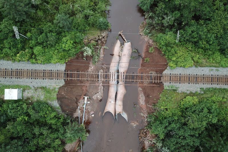 FILE PHOTO: Water flows through a washed-out culvert on the main CN Rail line in Truro